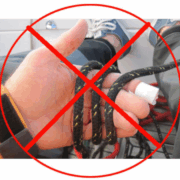 Sailing safety tip: Do not wrap rope around hand. Red crossed circle highlighting wrong technique.
