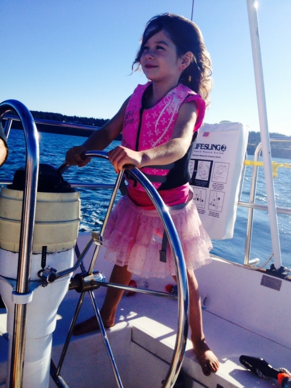Daughter takes the helm in a Tutu on a family sailing vacation