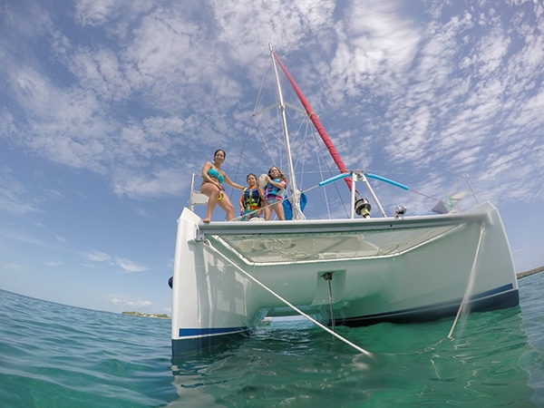Bahamas Abacos Yacht Charter and sailing vacations swimming off the bow of a catamaran