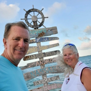 Calypso Sailing Life - Mark and Sharon Noneman with Caribbean sign