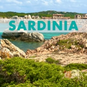 Scenic coastal view of Sardinia, highlighting rocky shoreline and turquoise waters, ideal for sailing adventures.