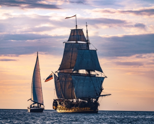 Pirate facts and quotes - a pirate ship anchored off the beach.