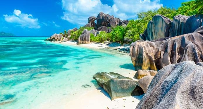 Tropical beach paradise with turquoise waters and unique rock formations, perfect for sailing adventures.