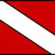 Red and white diver down flag indicating scuba diving activity or a submerged diver in the area.