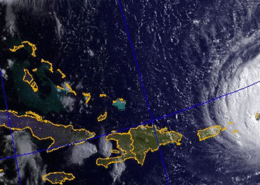 Satellite image of hurricane approaching Caribbean islands, highlighting storm path critical for sailing safety.