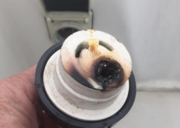 Burned marine shore power plug showing signs of electrical damage in hand, indicating potential safety hazard.