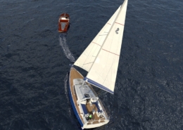 Aerial view of a sailboat and motorboat on open water, showcasing serene sailing experience and adventure.