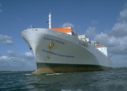 Large cargo ship in open water with humorous text on the bow reading, If you can read this, say goodbye to your mommy.