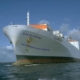 Large cargo ship in open water with humorous text on the bow reading, If you can read this, say goodbye to your mommy.
