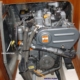 Sailboat engine with labeled oil dipstick and water pump, showcasing essential maintenance points.