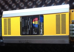 Yellow marine battery charger, TrueCharge 20+ model, designed for efficient onboard 12V power management.