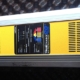 Yellow marine battery charger, TrueCharge 20+ model, designed for efficient onboard 12V power management.