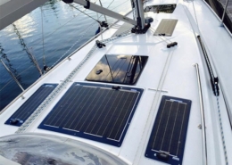 Sailboat deck with installed solar panels, capturing sunlight for sustainable energy on the water.