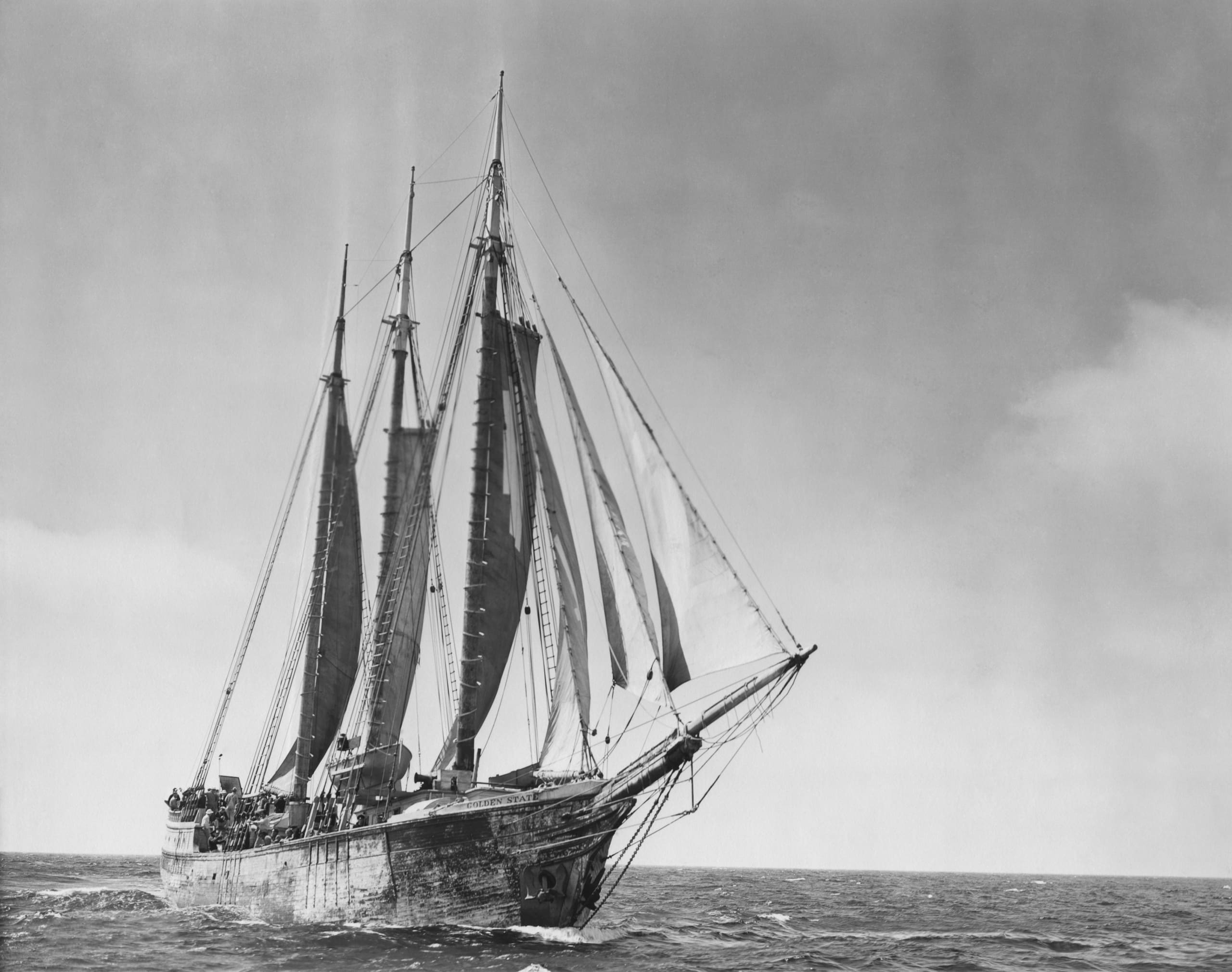 Historic schooner with three masts sailing on the open sea, capturing the essence of classic maritime travel.