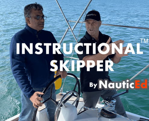 Two men discussing sailing techniques on a sailboat, part of NauticEd's Instructional Skipper program.