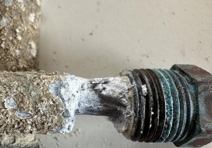 Corroded boat plumbing fitting with calcium buildup, highlighting maintenance needs for marine safety and efficiency.