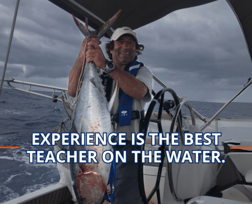 Sailor proudly holds a large fish on a yacht, showcasing a maritime catch under cloudy skies. Text: Experience is the Best Teacher.