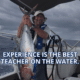 Sailor proudly holds a large fish on a yacht, showcasing a maritime catch under cloudy skies. Text: Experience is the Best Teacher.