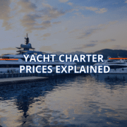 Luxury yachts docked at sunset with text: Yacht Charter Prices Explained.