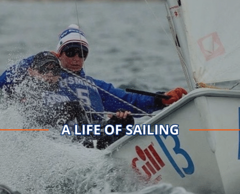 Sailors in action, navigating through waves in a dynamic sailing competition, showcasing sailing prowess. Meet Sailing Instructor Patrick Scollard