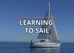 Sailboat on calm blue sea under clear sky, Learning to Sail text overlay.