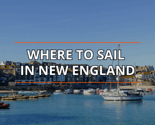 Discover top sailing locations in New England: picturesque harbor with boats and coastal town backdrop. best sailing towns in New England