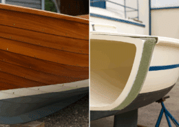 Close-up of elegant wooden and fiberglass sailboat hulls showcased outdoors, highlighting craftsmanship and design.