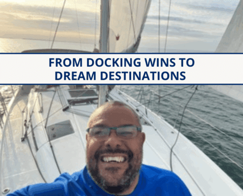 Smiling sailor on a sailboat at sea, enjoying a scenic cruise under a clear sky.