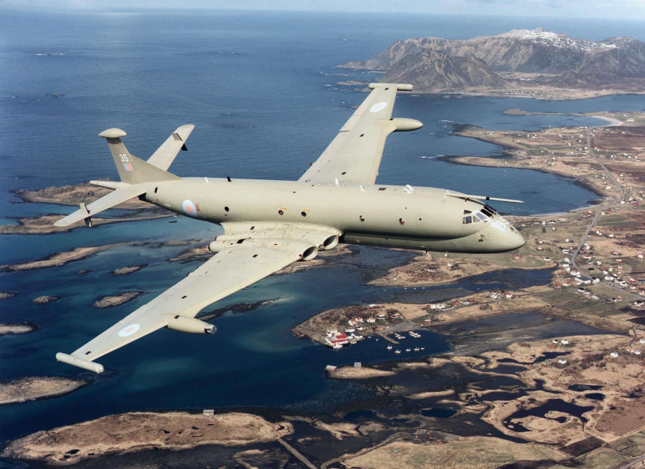 Military surveillance aircraft flying over coastal islands and blue ocean, showcasing advanced maritime patrol capabilities.