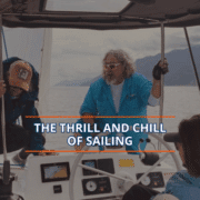 Sailors navigating a boat under cloudy skies, embracing the thrill and calm of a scenic sailing adventure.