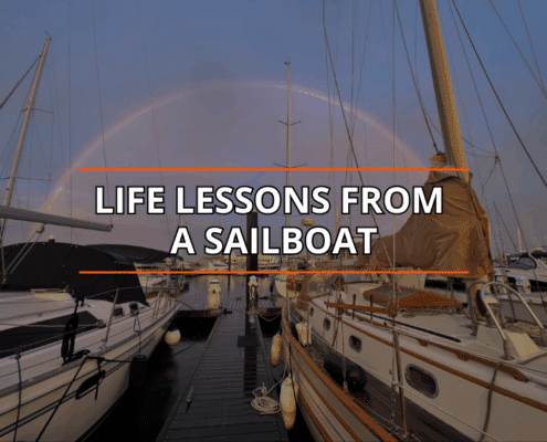 Sailboats docked under a rainbow; text reads Life Lessons from a Sailboat.