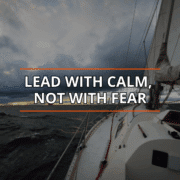 Sailing quote over a stormy sea, Lead with calm, not with fear, inspiring leadership and courage.