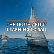 Sailboats gliding on blue water under clear skies; text reads The Truth About Learning to Sail.