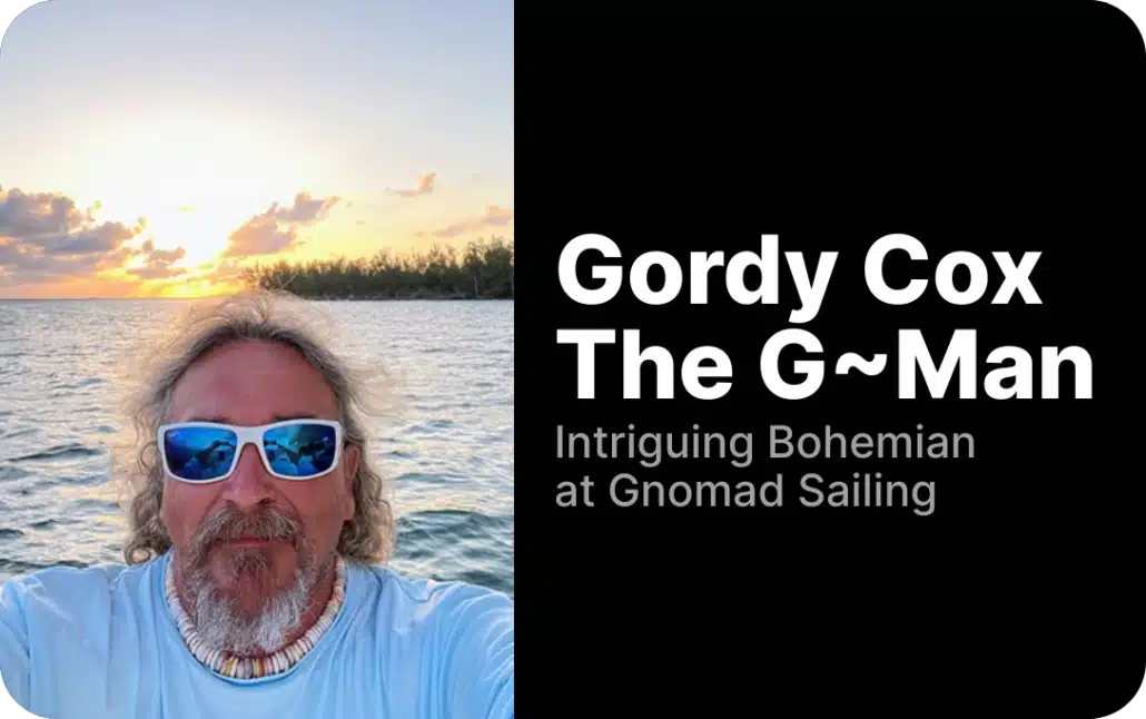 Sailor enjoying sunset at sea with blue sunglasses, promoting Gnomad Sailing adventures.