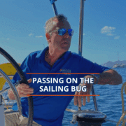 Man on sailboat enjoying ocean view, promoting sailing lifestyle.