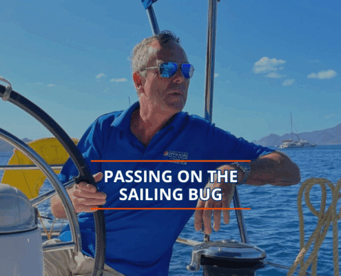 Man on sailboat enjoying ocean view, promoting sailing lifestyle.