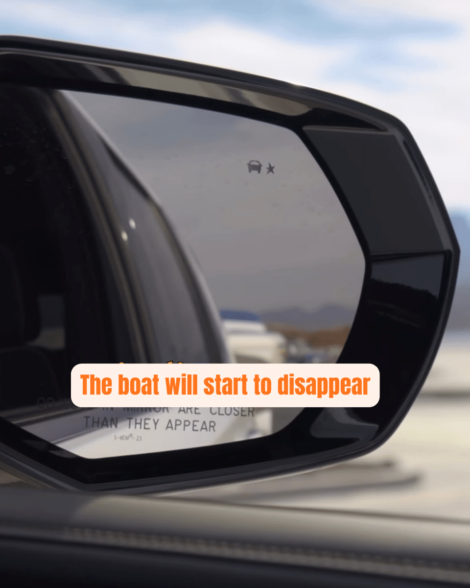 5 Car side mirror view with text The boat will start to disappear, highlighting perspective and distance on the road.