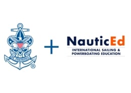 NauticEd partners with emblem featuring an eagle, enhancing international sailing and powerboating education.