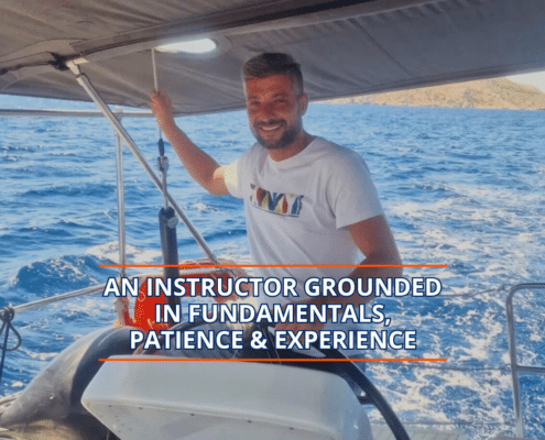 Smiling sailing instructor navigating a boat on the ocean, showcasing expertise and patience.
