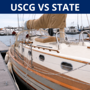 Sailboat docked at marina with text USCG VS STATE above, highlighting boating regulations.