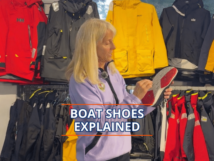 Boat shoes explained Woman explains features of boat shoes in a sailing gear shop.