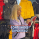 Woman explains features of boat shoes in a sailing gear shop.