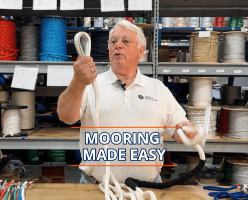 Expert sailor demonstrates mooring techniques with ropes in a nautical supply store, caption reads Mooring Made Easy.
