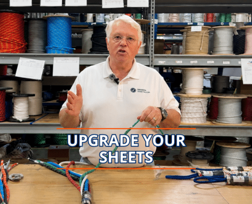 Expert sailor explaining rope selection for optimal sheet upgrades in a maritime supply store.
