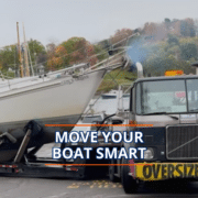 How to Transport a Boat After You Buy It Truck transporting sailboat on road, sign reads Oversize Load, with Move Your Boat Smart text overlay.