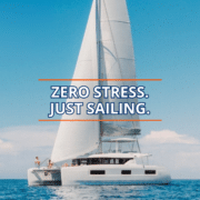 Your Complete Yacht Charter Vacation, Handled From Start to Finish Catamaran sails smoothly on a clear day, embodying the phrase Zero Stress. Just Sailing.