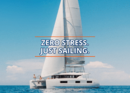 Catamaran sails smoothly on a clear day, embodying the phrase Zero Stress. Just Sailing.