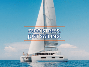 Catamaran sails smoothly on a clear day, embodying the phrase Zero Stress. Just Sailing.