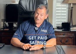 Man in office chair discussing opportunities to earn money through sailing, wearing a Landfall Sailing polo.