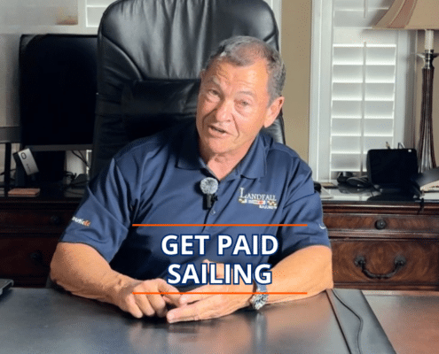 Man in office chair discussing opportunities to earn money through sailing, wearing a Landfall Sailing polo.